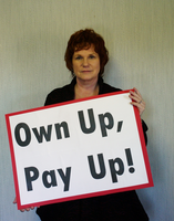 Sharon Bowles MEP holding sign saying Own Up, Pay Up!